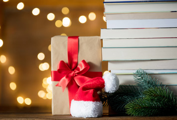 gift box, Santa Claus hat and pile of books