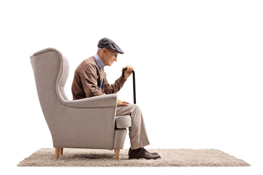 Depressed Elderly Man Seated In An Armchair