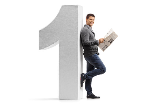 Man with a newspaper leaning against a cardboard number one
