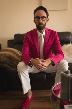 Man in well dressed relaxing on sofa in living room