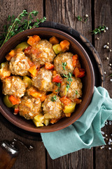 Meatballs stewed with vegetables on wooden table, top view