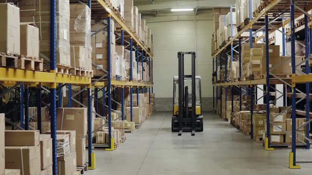 An interior of a warehouse with forklift.