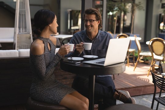Couple having cup of coffee in chocolate bar
