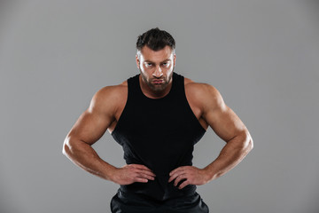 Fototapeta na wymiar Portrait of a muscular strong male bodybuilder standing