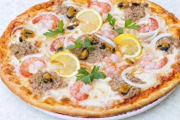 Sea gifts pizza with shrimps, mussels and tuna fish. Top view