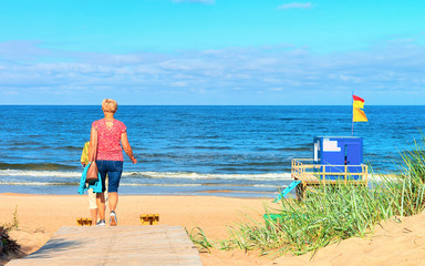 Women on Footpath through sand dune at Baltic Sea Palanga