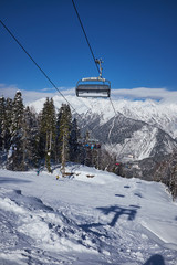 Skiers on the chairlift - ski resort during winter sunny day