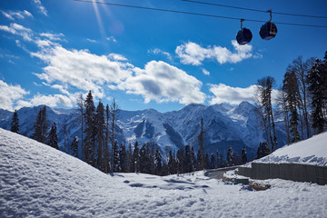 Fototapeta na wymiar Skiers on the chairlift - ski resort during winter sunny day