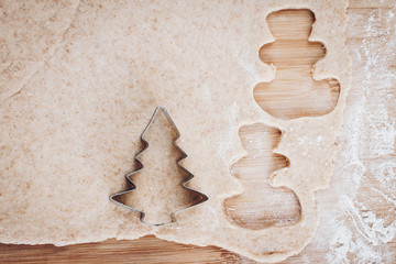 Preparing gingerbread dough for cookies with metal cutter