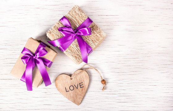Holiday decorations with gift boxes and wooden heart. St. Valentine's Day. Copy space