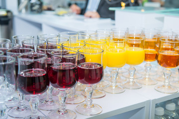Catering table with alcoholic and non-alcoholic drinks on the business event in the hotel hall. Service at business meeting, party, weddings. Selective focus, space for text.