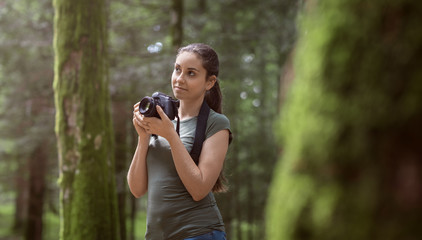 Photographer taking pictures in the forest