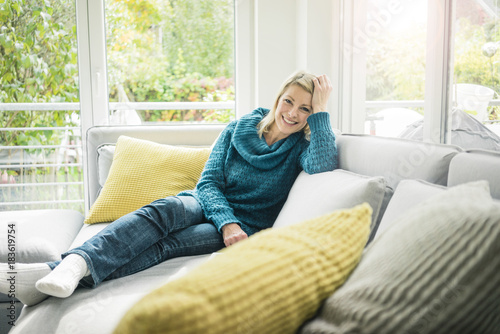 Portrait Of Hy Woman Relaxing On Couch Stock Photo And Royalty Portrait Of Hy Woman Relaxing On Couch