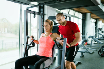 Beautiful girl working out with personal trainer
