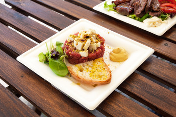 Delicious steak tartare raw beef on white plate.