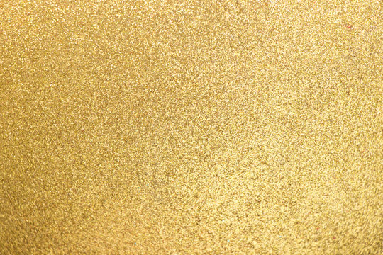Closed up of metallic gold glitter textured background