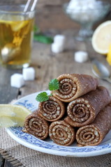 Russian pancakes wrapped in rolls. Traditional carnival meal.