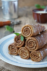 Russian pancakes wrapped in rolls. Traditional carnival meal.