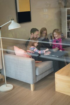 Family using digital tablet in living room