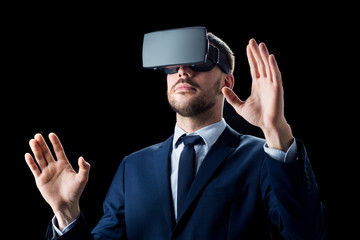 businessman in virtual reality headset over black