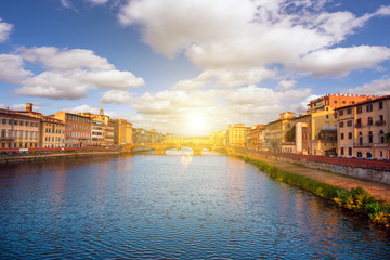 Beautiful city view with the famous medieval stone bridge Ponte Vecchio over the Arno river in Florence, Italy. Place of pilgrimage for tourists.