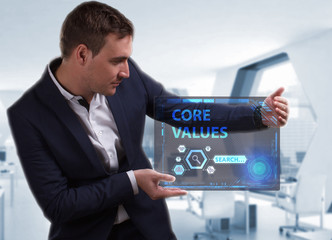 Business, Technology, Internet and network concept. Young businessman working on a virtual screen of the future and sees the inscription: Core values