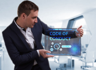 Business, Technology, Internet and network concept. Young businessman working on a virtual screen of the future and sees the inscription: Code of conduct