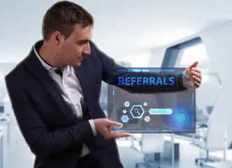 Business, Technology, Internet and network concept. Young businessman working on a virtual screen of the future and sees the inscription: Referrals