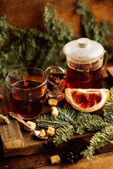 hot pink tea with cinnamon in a transparent mug, rustic style
