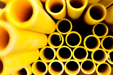 Yellow PVC tubes in storage, Plastic tubes, Background of PVC,Water pipes wallpaper background.