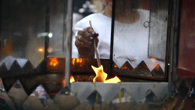 Religious Senior Woman Burning Incense In Chinese Temple. Slow Motion. HD, 1920x1080. 