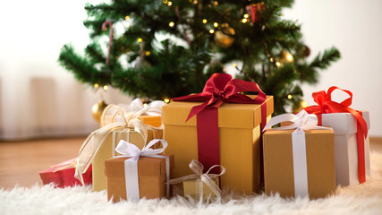 Fototapeta na wymiar gift boxes on sheepskin at christmas tree