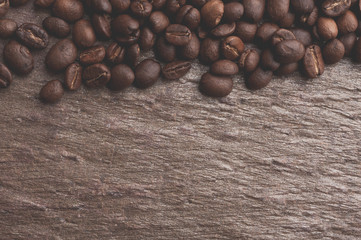 Coffee beans on stone background. Top view with copy space for your text