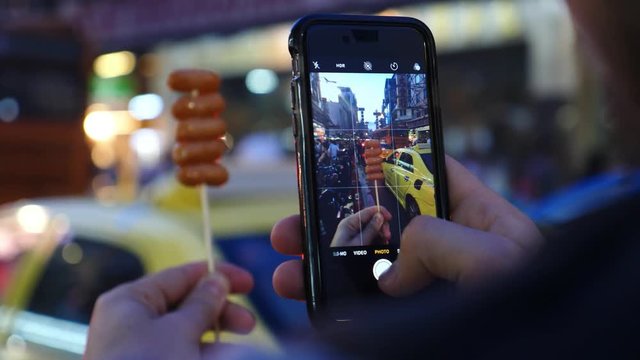 Tourist Taking Picture With Smartphone Of Fried Street Food In Chinatown. Closeup. 4K. 
