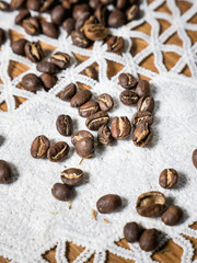 Fototapeta na wymiar coffee beans on white vintage tablecloth