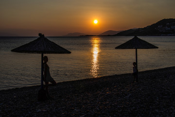 sunset and silhouettes under the umbrella