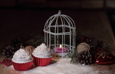 cupcakes,Christmas candle and Christmas decorations on wooden ba