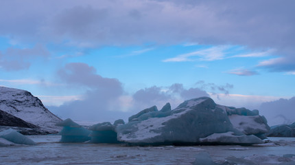 Blue iceberg in frozen lagoon, Fjallsárlón Iceland
