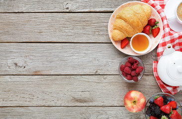 Tasty pastry, fruits and berries on rustic wood, top view