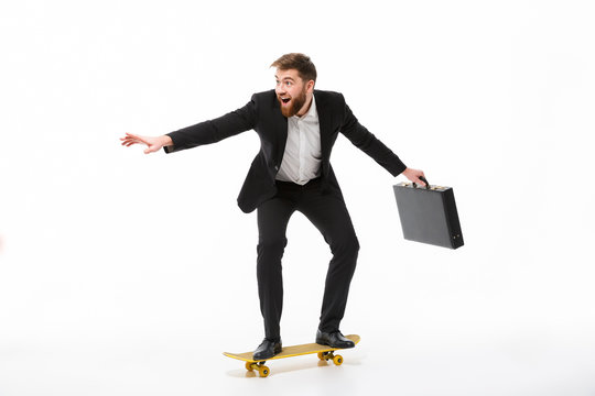 Full length image of Playful bearded business man with briefcase