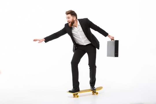 Full length image of Cheerful bearded business man with briefcase