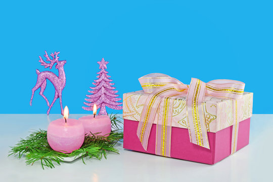 Christmas background, greeting card with two burning candles, decorations, gift and fir branches