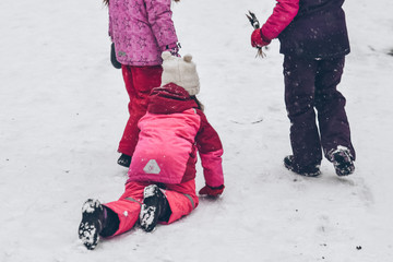 group of kids playing outside in winter day
