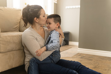 mother with boy sitting on couch at home
