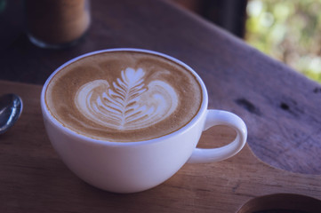 coffee latte art aroma on wood table vintage in coffee shop cafe , relax time on coffee bar