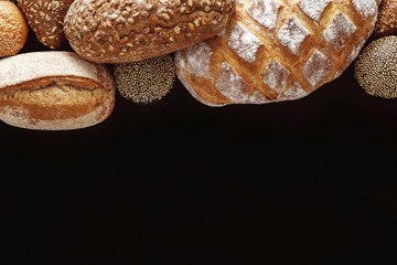 Bakery concept. Plenty of bread background isolated on balck