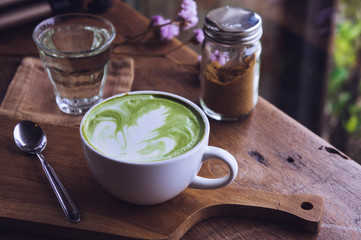 green tea hot drink latte white cup on wood table aroma relax time in coffee shop