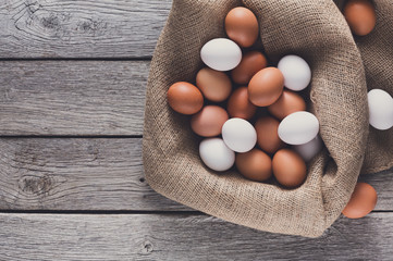 Fresh chicken brown eggs on sack, organic farming background