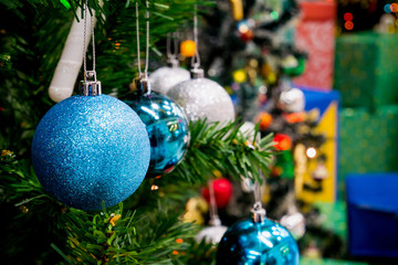 Decorated Christmas tree with colorful bauble on sparkling bokeh light blurred background