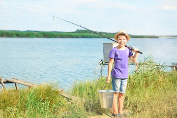 Fototapeta na wymiar Cute boy going fishing on summer day